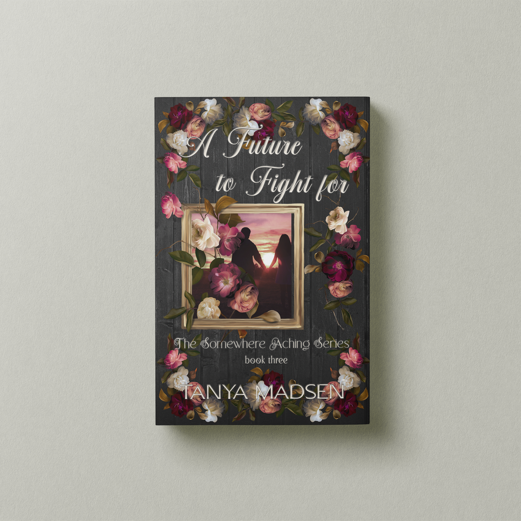 A front‑facing image of the book A Future to Fight For, surrounded by a floral design. The cover shows a silhouette of a couple holding hands staring at the sunrise. The book is set against a sage‑green background.