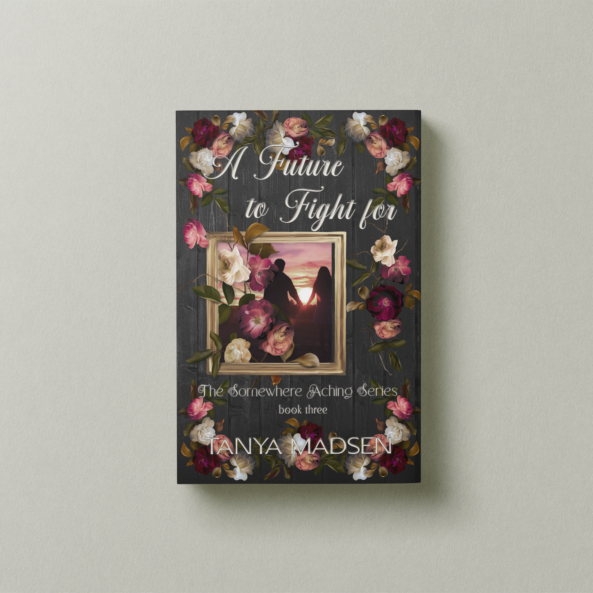 A front‑facing image of the book A Future to Fight For, surrounded by a floral design. The cover shows a silhouette of a couple holding hands staring at the sunrise. The book is set against a sage‑green background.