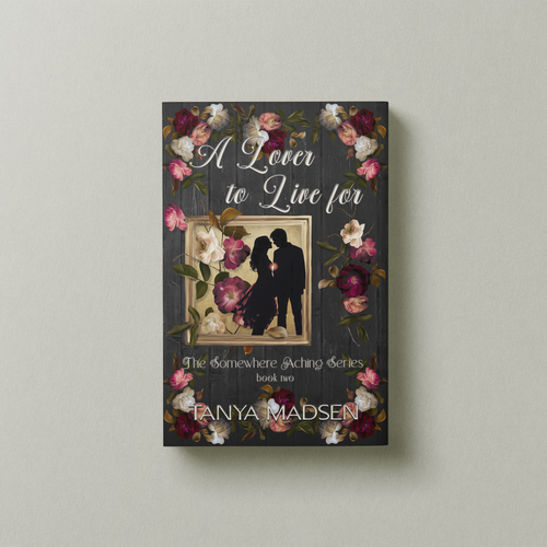 A front‑facing image of the book A Lover to Live For, surrounded by a floral design. The cover shows a silhouette of a couple almost kissing, the sun peaking between them. The book is set against a sage‑green background.