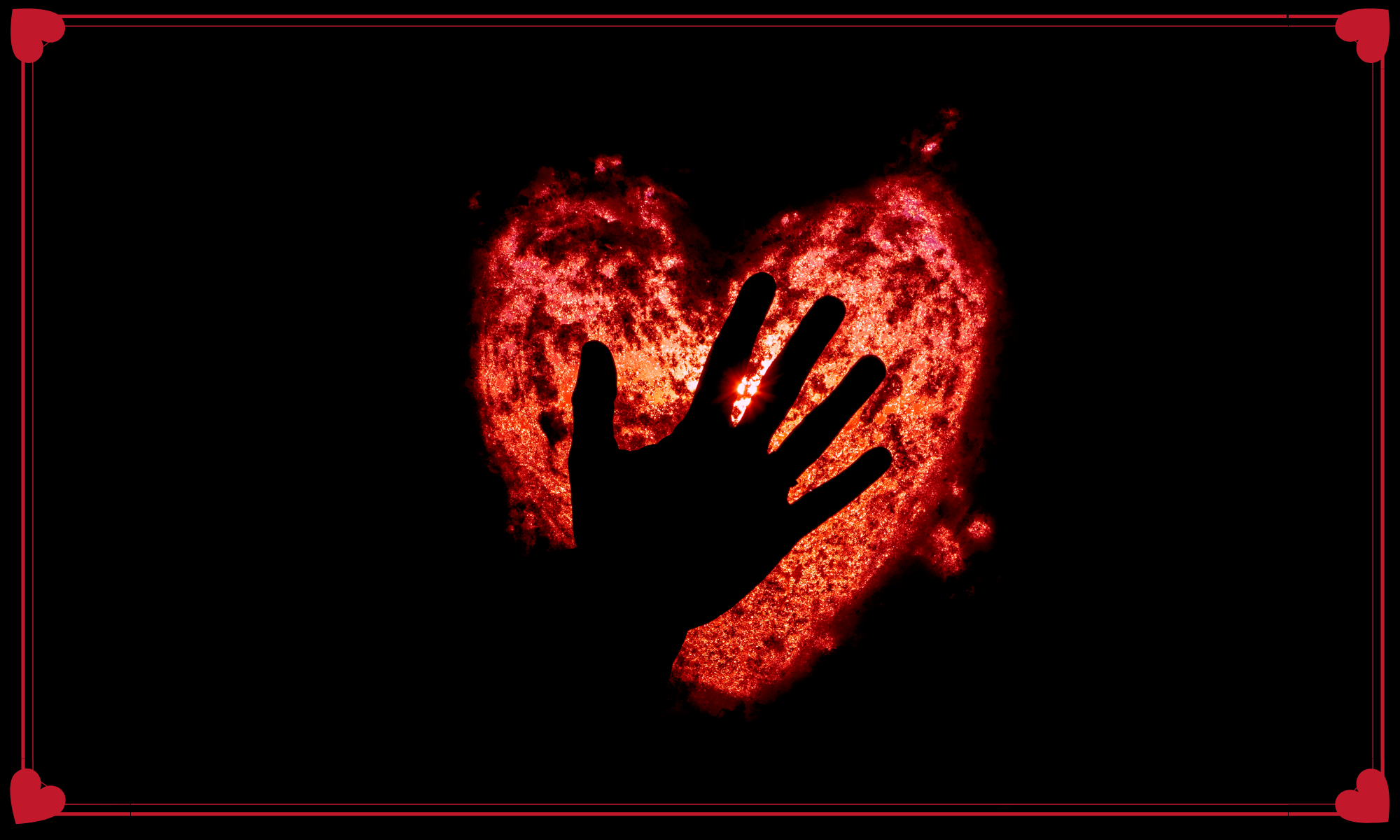 Heart-shaped light with a hand silhouette against a dark background