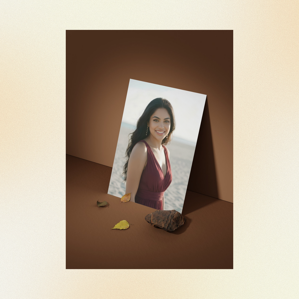 A photo of Judith displayed against a brown wall, smiling at the camera with green eyes, wearing a burgundy dress.