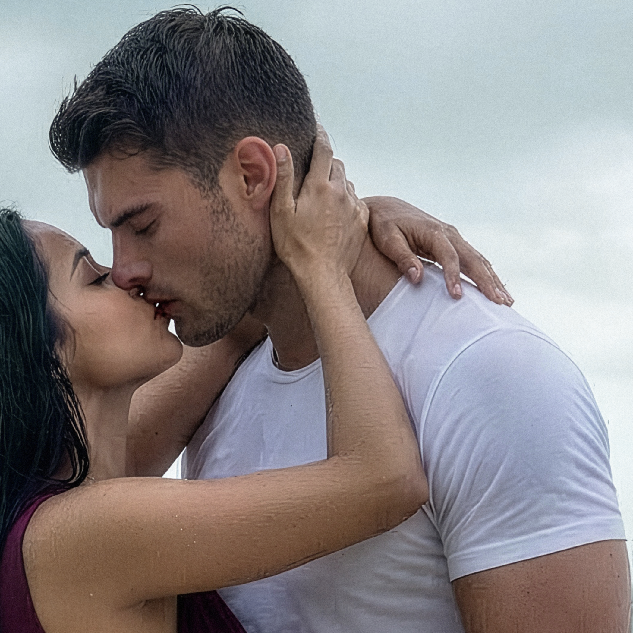 A close-up photo of Justin and Judith embracing passionately in the rain.