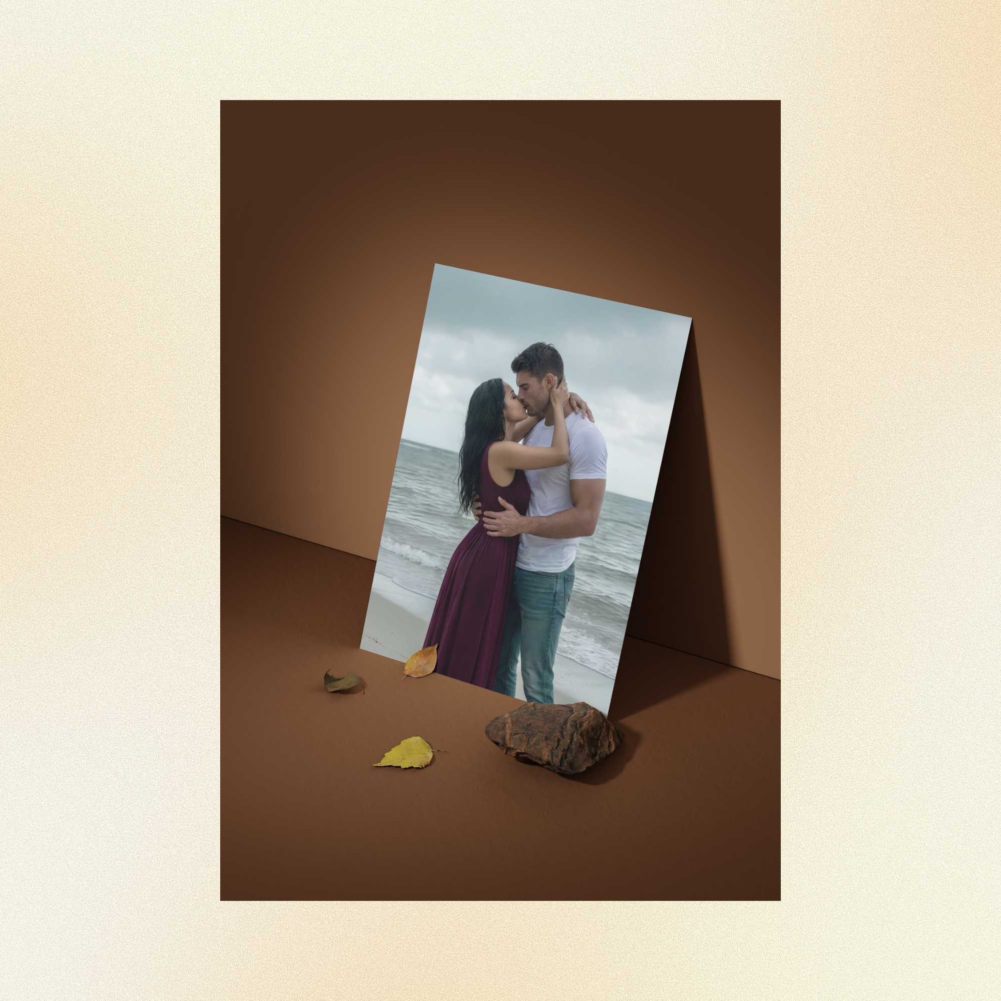 A photo displayed against a brown wall of Judith and Judith embracing passionately in front of a stormy ocean. 