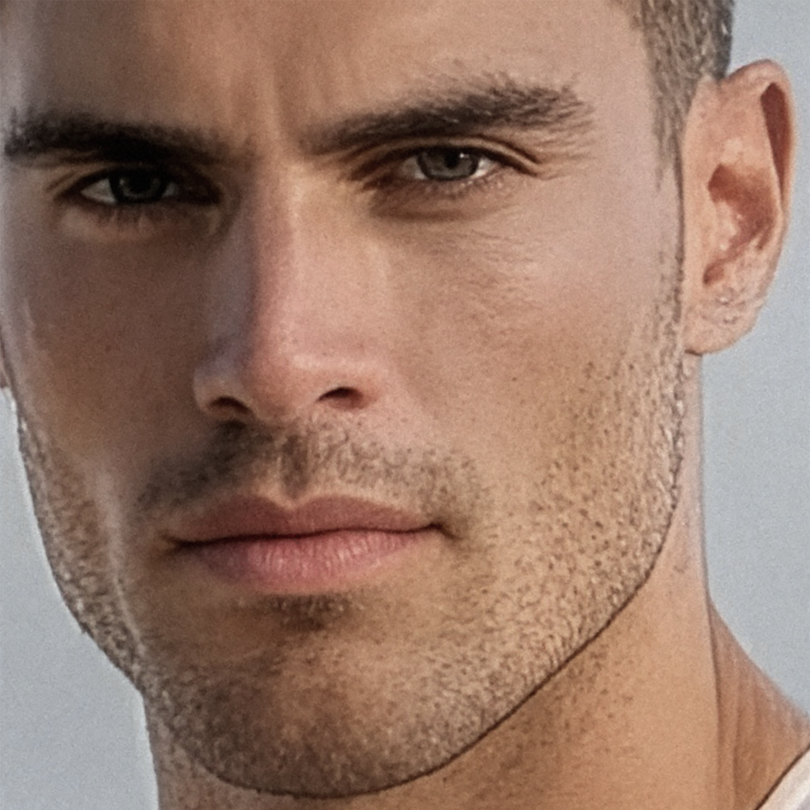 A close-up photo of Justin staring intensely at the camera, his dark brown eyes filled with passion and mystery.