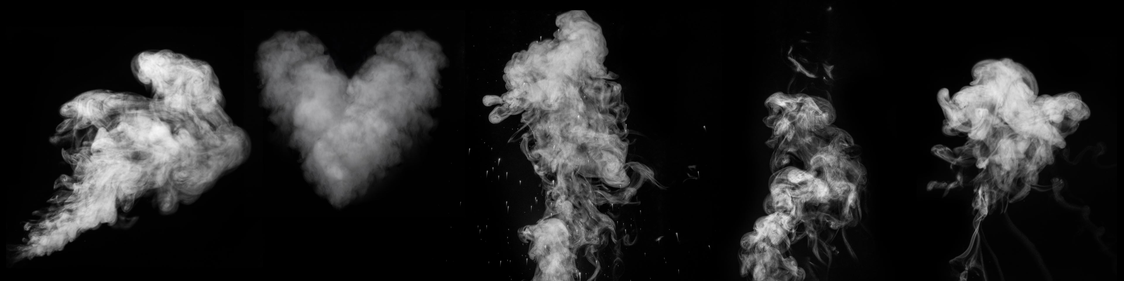 Heart-shaped cloud of smoke surrounded by other cloud shapes on a black background