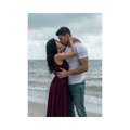 A photo of Justin and Judith embracing passionately in the rain in front of a stormy ocean. 