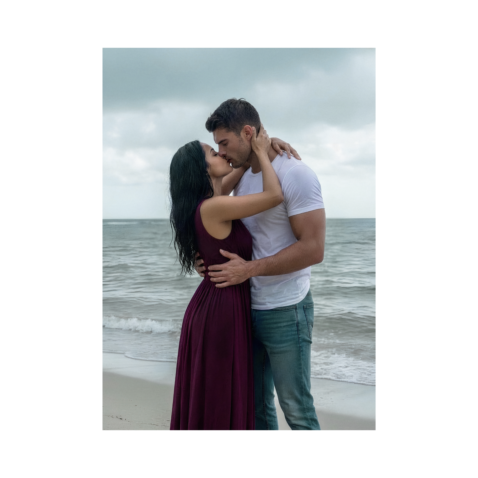 A photo of Justin and Judith embracing passionately in the rain in front of a stormy ocean. 