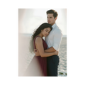 A photo of Judith hugging Nicolas in front of the ocean her head laying against is chest, her expression is one of serenity and joy, his eyes reflect pure contentment.