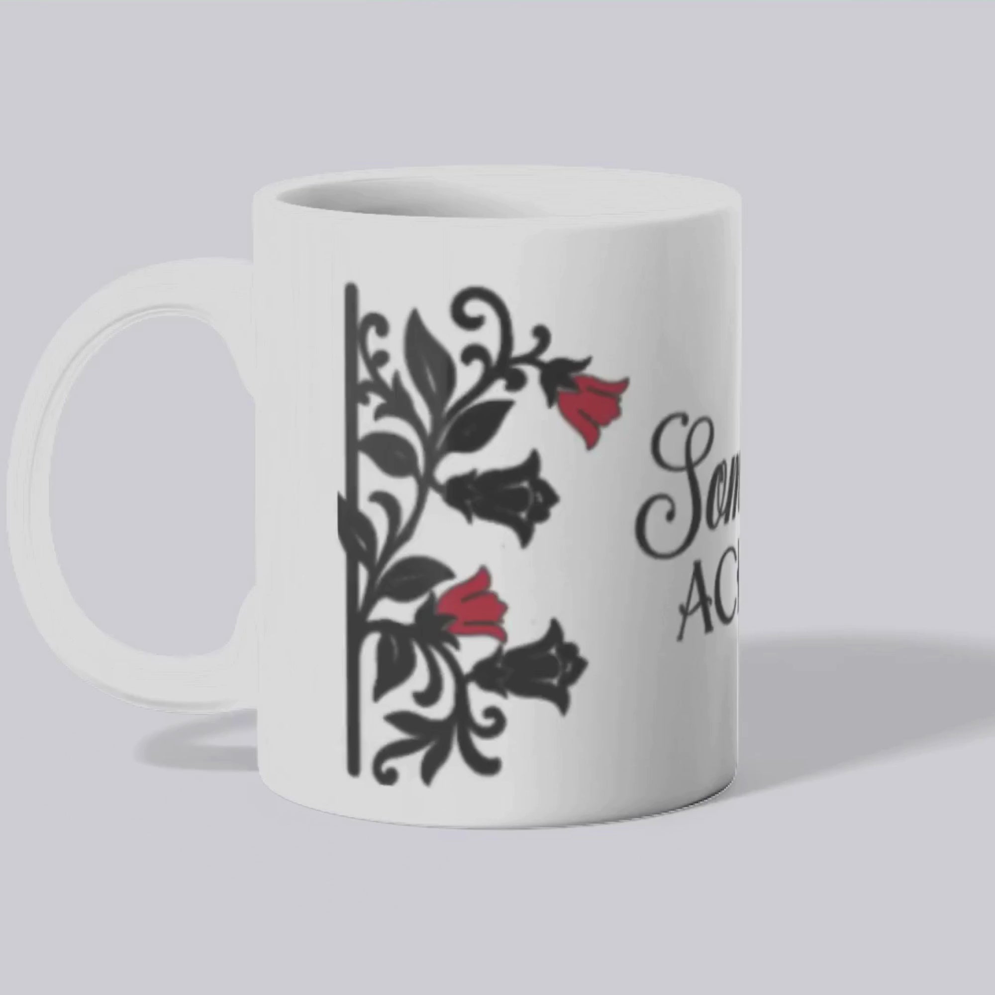 A mockup of the Somewhere Aching mug featuring black floral designs with red belladonna flowers on a white background.