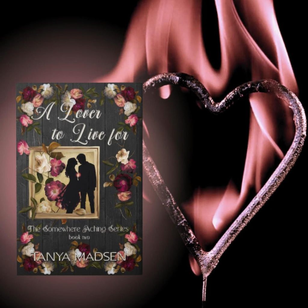 A short video showing the front cover of A Lover to Live For, featuring a silhouette of a couple leaning in for a kiss surrounded by floral elements. Beside the book lies a metallic pink heart on a black background that ignites into soft pink flames.